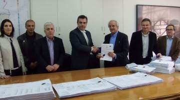 Constantinos Yiorkadjis, mayor, Nicosia, (L) and Stavros Theodosiou, CEO, A.Panayides Contracting with other municipality and company staff